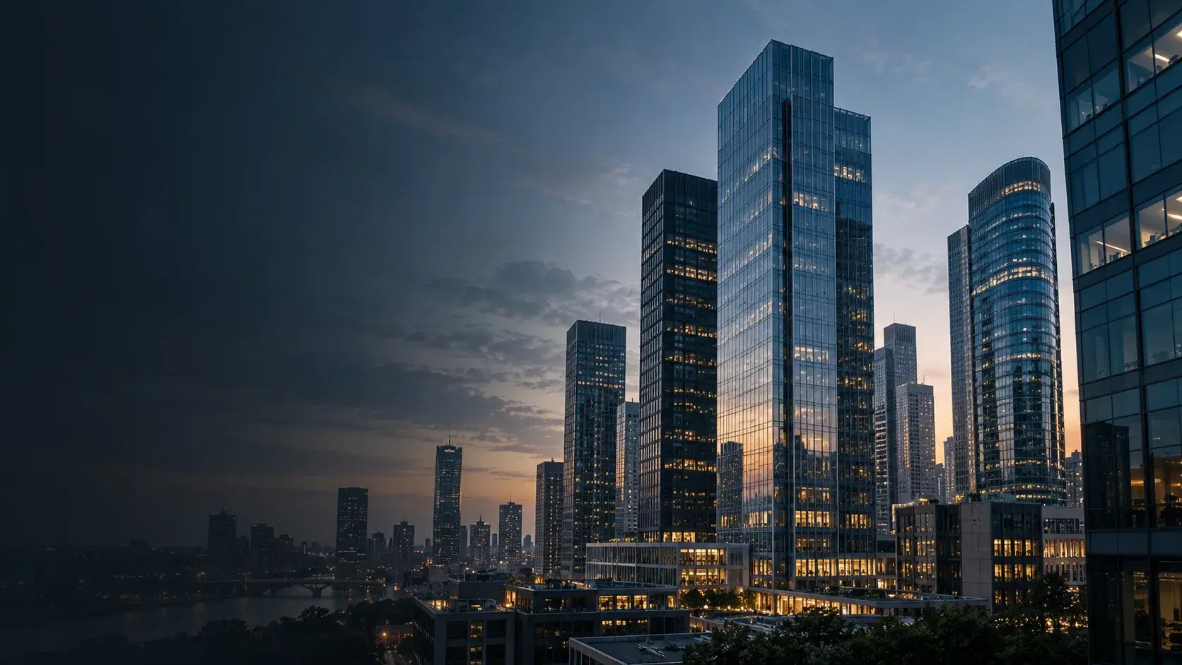 Glass residential towers across a city skyline at dusk, windows lit