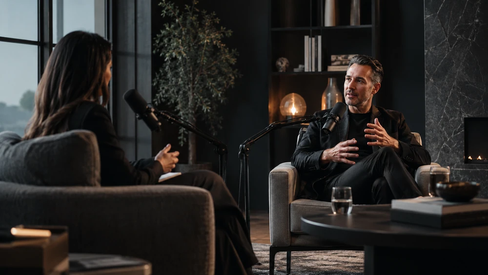 A podcast host interviewing a real estate leader